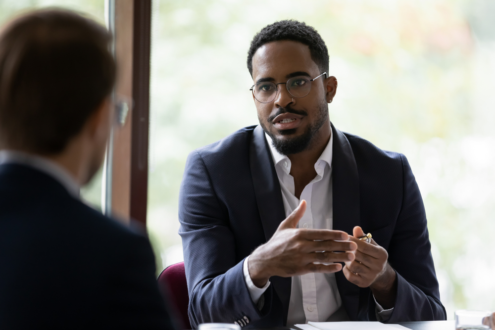 african american male boss speaking to colleague