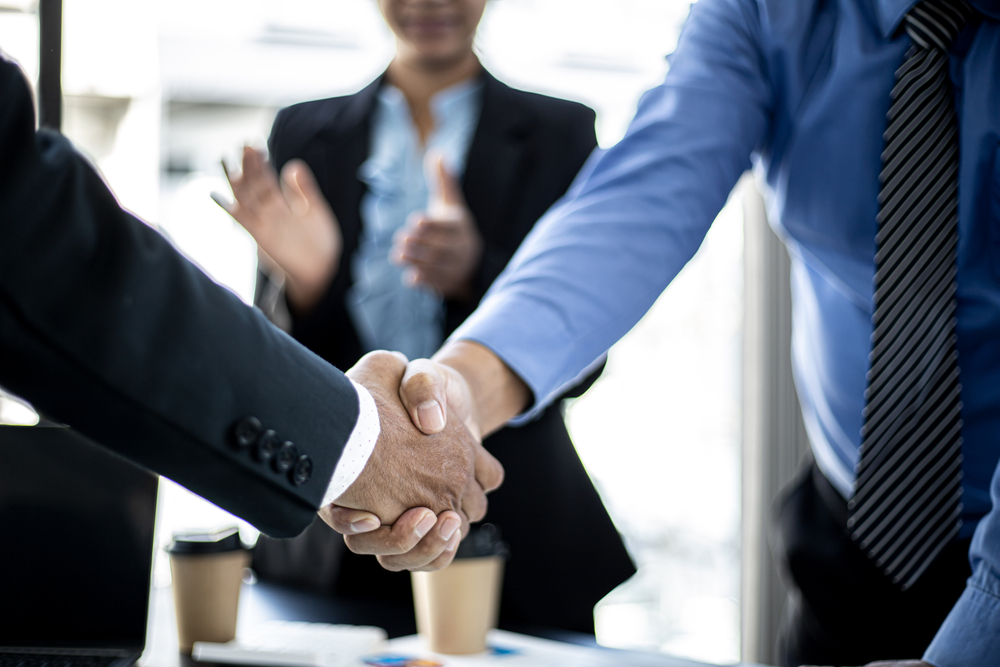 close up of two businessmen shaking hands