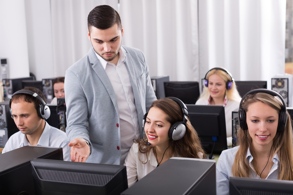 Happy call center employees using live chat