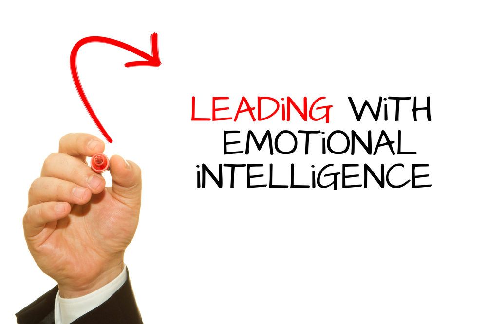 Businessman hand writing the words Emotional Intelligence on a whiteboard in red - Freeway franchise